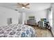 Bedroom featuring a TV, computer desk, and wood-look flooring at 1552 Whooping Dr, Groveland, FL 34736