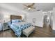 Bright bedroom with a decorative bed, mirrored nightstands, and wood-look flooring at 1552 Whooping Dr, Groveland, FL 34736