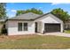 Picture of a charming single-story house with a tidy lawn and two-car garage at 1552 Whooping Dr, Groveland, FL 34736