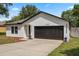 Charming single-story home featuring a two-car garage, fresh paint, and tidy landscaping at 1552 Whooping Dr, Groveland, FL 34736
