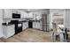 Bright kitchen with stainless steel appliances and a glass top table with chairs at 1552 Whooping Dr, Groveland, FL 34736