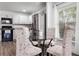 Bright kitchen with stainless steel appliances, wooden floor, and glass table with four chairs at 1552 Whooping Dr, Groveland, FL 34736