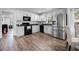 Bright kitchen with stainless steel appliances, white cabinets, and black appliances at 1552 Whooping Dr, Groveland, FL 34736