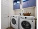 Bright laundry room with side by side washer and dryer, and upper cabinets at 1552 Whooping Dr, Groveland, FL 34736