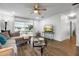 This is an open-plan living space with wood-look floors and a view to the patio at 1552 Whooping Dr, Groveland, FL 34736
