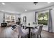 Living room with natural light, hardwood floor, and stylish furniture arrangement at 1552 Whooping Dr, Groveland, FL 34736