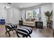 Cozy living area with a bright window, stylish furniture, and wood-look flooring at 1552 Whooping Dr, Groveland, FL 34736