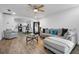Open-plan living space with wood-look floors flowing into the kitchen and dining area at 1552 Whooping Dr, Groveland, FL 34736