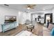 This living room flows into the kitchen and dining area, and features wood-look floors at 1552 Whooping Dr, Groveland, FL 34736
