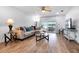Living room overlooking water, with sliding glass doors, couch, and wood-look flooring at 1552 Whooping Dr, Groveland, FL 34736