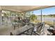 Screened porch offering tranquil lake views and cozy patio seating at 1552 Whooping Dr, Groveland, FL 34736