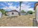 Spacious backyard showing the rear of the house, fence and mature trees at 15628 Hidden Lake Cir, Clermont, FL 34711