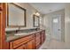 Bathroom with double vanity, granite counters, and tile flooring at 15628 Hidden Lake Cir, Clermont, FL 34711