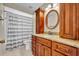 Bathroom with a single sink vanity and a shower with a curtain at 15628 Hidden Lake Cir, Clermont, FL 34711