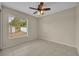 Bedroom with tile floors and ceiling fan; natural light fills the room through the window at 15628 Hidden Lake Cir, Clermont, FL 34711