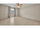 Bright bedroom features a ceiling fan and tile flooring throughout at 15628 Hidden Lake Cir, Clermont, FL 34711