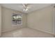 Bedroom with tile flooring and ceiling fan; bright window provides natural light at 15628 Hidden Lake Cir, Clermont, FL 34711