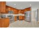 Modern kitchen with stainless steel appliances and ample cherry wood cabinetry at 15628 Hidden Lake Cir, Clermont, FL 34711