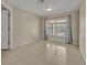 Spacious room with neutral tile, a large window, and easy access to other rooms at 15628 Hidden Lake Cir, Clermont, FL 34711
