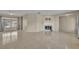 Bright living area featuring neutral tile, a fireplace, and ample natural light from the adjacent windows at 15628 Hidden Lake Cir, Clermont, FL 34711