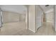 Spacious living room with tile floors and neutral walls with easy access to other rooms at 15628 Hidden Lake Cir, Clermont, FL 34711