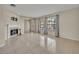 Bright living area featuring neutral tile, a fireplace, and ample natural light from the adjacent windows at 15628 Hidden Lake Cir, Clermont, FL 34711
