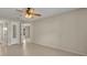 Bright living room with neutral walls, ceiling fan, and tile flooring throughout at 15628 Hidden Lake Cir, Clermont, FL 34711