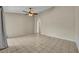 Spacious living room with ceiling fan and tile flooring throughout the home at 15628 Hidden Lake Cir, Clermont, FL 34711