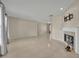 Bright living area featuring neutral tile, a fireplace, and ample natural light from the adjacent windows at 15628 Hidden Lake Cir, Clermont, FL 34711