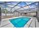 Screened-in pool with clear blue water offering a refreshing outdoor experience at 15628 Hidden Lake Cir, Clermont, FL 34711