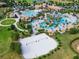 Beautiful aerial view of community pool with lazy river, volleyball court, and clubhouse at 1596 Moon Valley Dr, Davenport, FL 33896