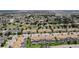 Wide aerial showcasing an expansive community with various housing styles, verdant landscaping, and orderly street layouts at 1596 Moon Valley Dr, Davenport, FL 33896
