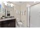 Bathroom featuring granite countertop, a vessel sink, toilet, and walk-in shower at 1596 Moon Valley Dr, Davenport, FL 33896