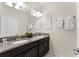 Bathroom featuring double vanity, granite countertop, dual sinks, and modern fixtures at 1596 Moon Valley Dr, Davenport, FL 33896