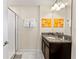 Bathroom featuring glass enclosed shower, granite countertop, and decorative mirror at 1596 Moon Valley Dr, Davenport, FL 33896