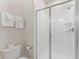 Bathroom featuring a glass enclosed shower, toilet, and fresh white towels at 1596 Moon Valley Dr, Davenport, FL 33896