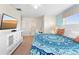 Bright bedroom with a decorative bedspread, television, and ensuite bathroom at 1596 Moon Valley Dr, Davenport, FL 33896