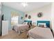 Inviting bedroom with two twin beds, colorful decor, and ample natural light creating a serene atmosphere at 1596 Moon Valley Dr, Davenport, FL 33896