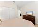Cozy bedroom with a closet and a television atop a wooden dresser at 1596 Moon Valley Dr, Davenport, FL 33896
