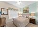 Cozy bedroom featuring a queen bed, stylish nightstands, and decorative accents with natural light at 1596 Moon Valley Dr, Davenport, FL 33896