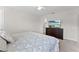 A bright bedroom showcasing a modern bed, dresser with TV, and neutral carpet at 1596 Moon Valley Dr, Davenport, FL 33896
