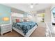 Bedroom featuring blue accent wall, ceiling fan, large bed, and carpeted floors at 1596 Moon Valley Dr, Davenport, FL 33896