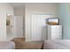 Bright bedroom with two twin beds and a white dresser with a television, alongside a closet at 1596 Moon Valley Dr, Davenport, FL 33896