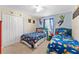 A bedroom decorated with vibrant colors, wall decals, and comfortable matching beds at 1596 Moon Valley Dr, Davenport, FL 33896