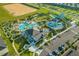 Aerial perspective of community amenities including pools, water slides, mini golf, and ample parking at 1596 Moon Valley Dr, Davenport, FL 33896