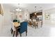 Bright dining area featuring a chandelier and an island with bar stool seating opening to the kitchen at 1596 Moon Valley Dr, Davenport, FL 33896