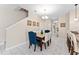 Inviting dining area with stylish tile flooring, chandelier, and neutral color scheme for flexible decorating at 1596 Moon Valley Dr, Davenport, FL 33896
