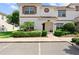 Attractive townhouse showcasing neat landscaping, white exterior, and contrasting trim for appealing curb appeal at 1596 Moon Valley Dr, Davenport, FL 33896