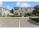 Well-manicured townhouse featuring clean white exterior, contrasted by brown trim and lush front yard landscaping at 1596 Moon Valley Dr, Davenport, FL 33896