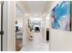 Bright hallway featuring modern tile floors that leads to dining room, bedrooms, and living spaces at 1596 Moon Valley Dr, Davenport, FL 33896